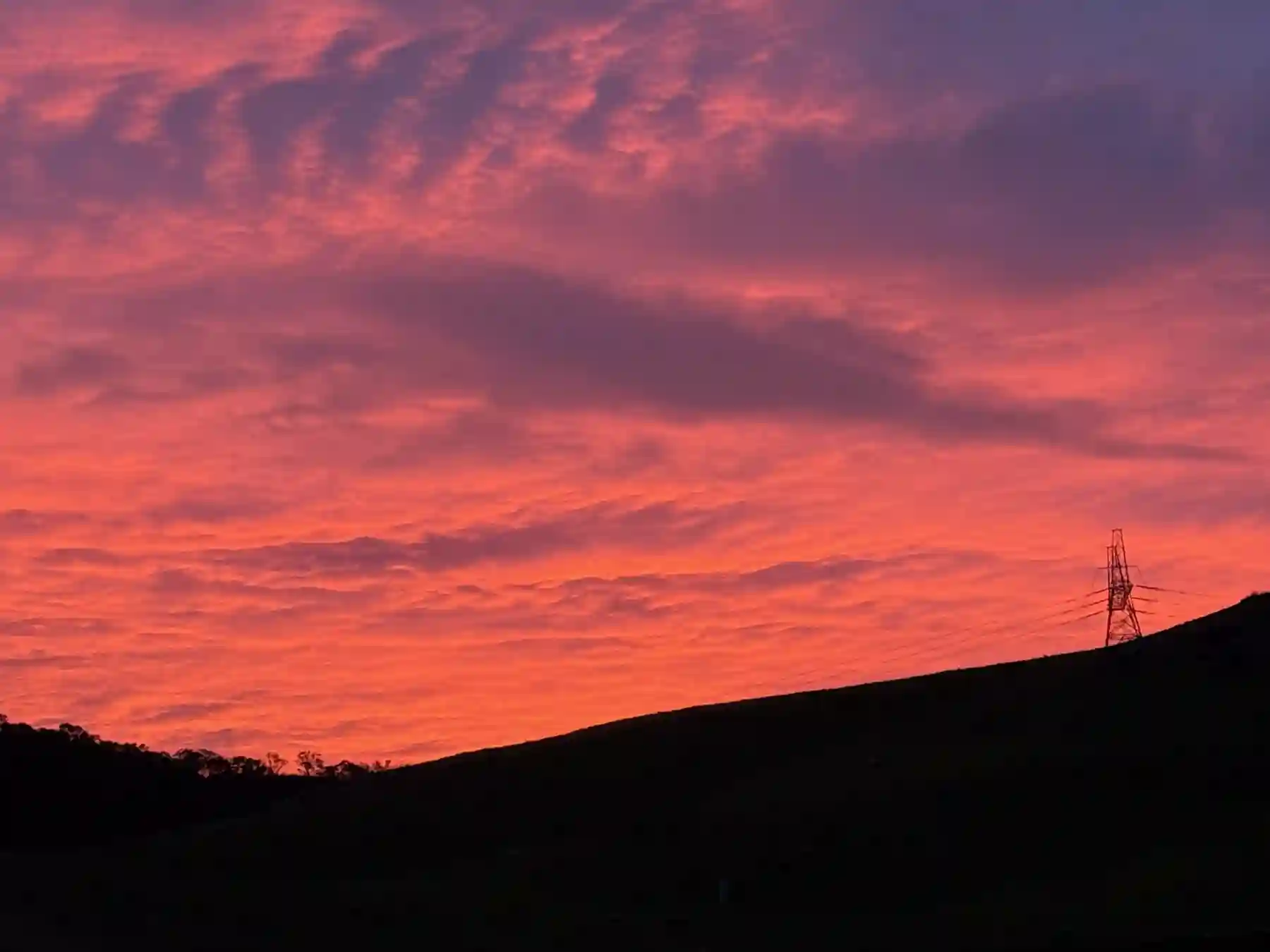 A vivid sunset beyond the ridge