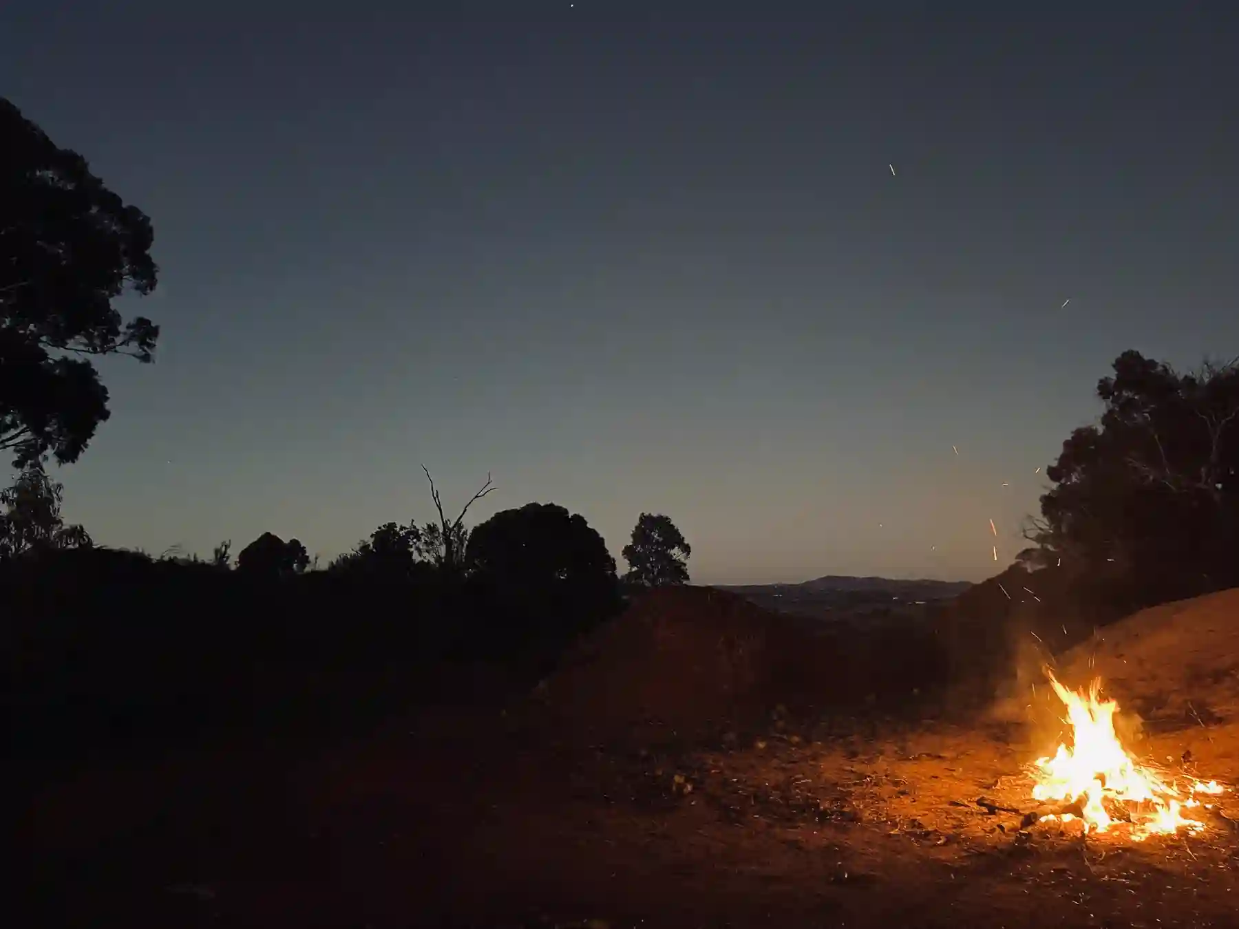A campfire as night settles